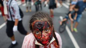 A girl takes part in the annual Zombie Walk at Copacabana beach in Ri
