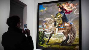 A man takes a picture of a painting by Kehinde Wiley depicting Michae