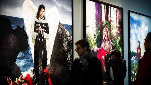 People walk past pictures of Michael Jackson by David LaChapelle at t