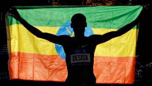 TOPSHOT - Lelisa Desisa of Ethiopia crosses the finish line to win th