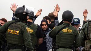 TOPSHOT - Pro-migrants activists demonstrate next to US border patrol