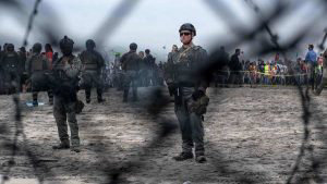 TOPSHOT - US border patrol agents surround pro-migrants activists as
