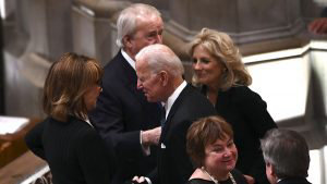 Former US Vice President Joe Biden(C) arrives for the funeral service