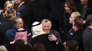 Jordan's King Abdullah II(C)and Queen Rania arrive before the funeral