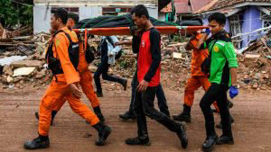 Members of an Indonesian search and rescue team carry the body of a v