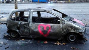 A picture shows a burned car in a street of Paris on December 2