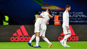 Real Madrid's Spanish midfielder Marcos Llorente (L) celebrates after