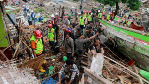 Rescuers look for survivors along the coast in South Lampung on South