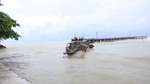 TOPSHOT - A damaged jetty is seen in Carita on December 23