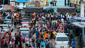 Residents disembark from a ferry at the port after being evacuated fr