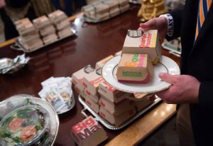 A guest selects fast food that the US president purchased for a cerem