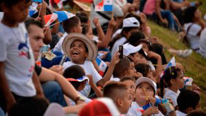 Children wait to see a glimpse of Pope Francis on his way from Panama