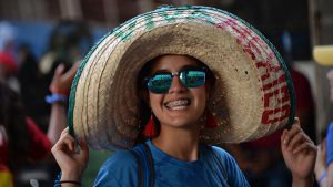 A pilgrim wearing a Mexican sombrero smiles for a photo in Panama Cit