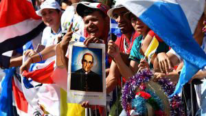 Faithfuls display a poster of Salvadorean Saint Oscar Arnulfo Romero
