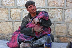 TOPSHOT - A Syrian man weeps as he cradles the body of his daughter w