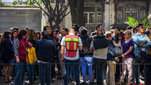People wait on the streets after an earth tremor in Mexico City on Fe
