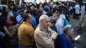 People wait on the streets after an earth tremor in Mexico City on Fe