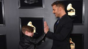 Puerto Rican singer Ricky Martin and son high five as they arrive for