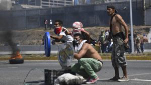 Opposition demonstrators clash with soldiers loyal to Venezuelan Pres