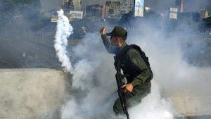TOPSHOT - A member of the Bolivarian National Guard supporting Venezu