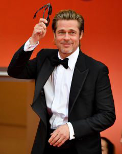 US actor Brad Pitt greets the crowd as he arrives for the screening o