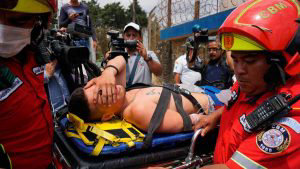 EDITORS NOTE: Graphic content / Firemen carry on a stretcher an injur