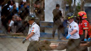 EDITORS NOTE: Graphic content / Firemen remove a dead inmate at the P