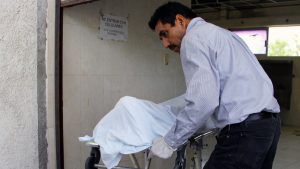 The corpse of Salvadoran migrant Oscar Martinez is prepared to be tra