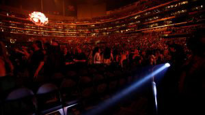 An usher uses a flashlight to clear the front row during an earthquake ahead of a concert by Shawn Mendes at Staples Center in Los Angeles