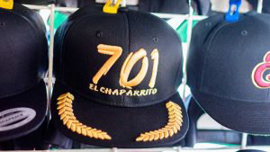 View of caps displayed for sale with embroideries of the number 701 -