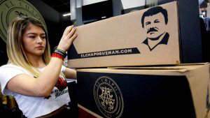 A woman places boxes containing clothing by 