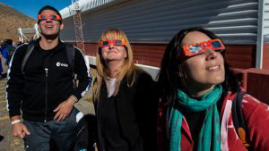 Tourists wear special glasses ahead of a solar eclipse at La Silla Eu