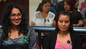 Salvadorean rape victim Evelyn Hernandez (R) sits next to one of her