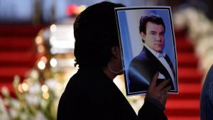 A person holds a picture of late Mexican singing legend Jose Jose dur