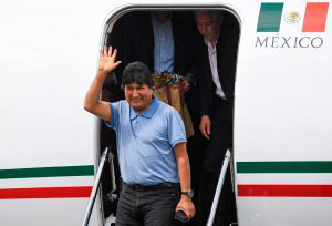 Bolivian ex-President Evo Morales waves upon landing in Mexico City