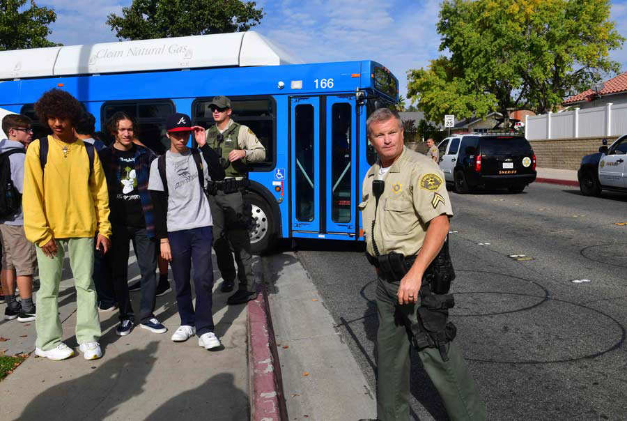 Students line up after a shooting at Saugus High School in Santa Clar