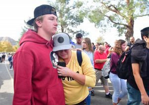 People react near Central Park after a shooting at Saugus High School