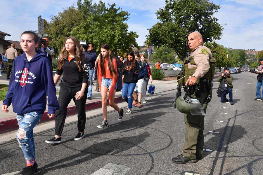 Students line up after a shooting at Saugus High School in Santa Clar