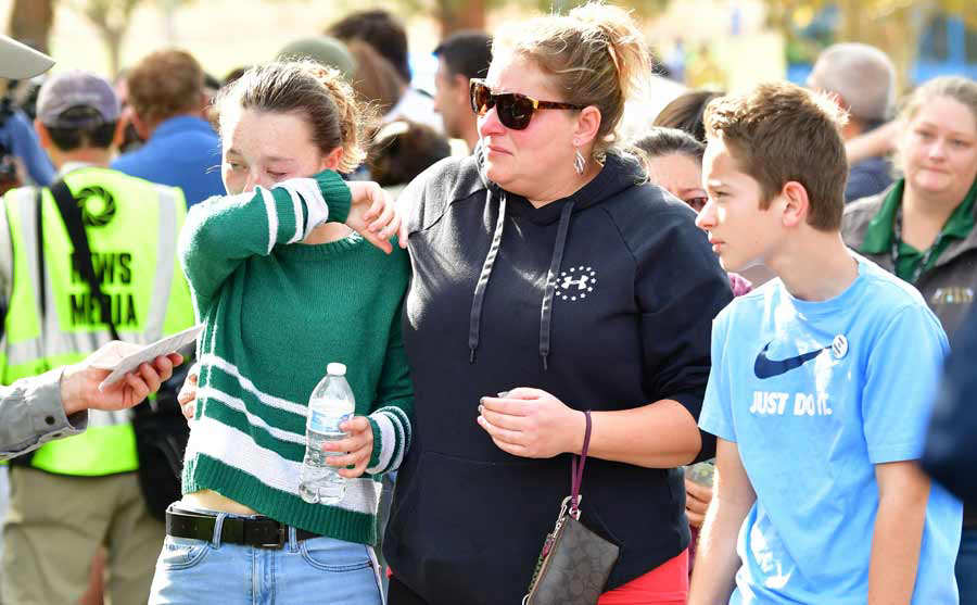 Students and parents embrace after being picked up at Central Park  a