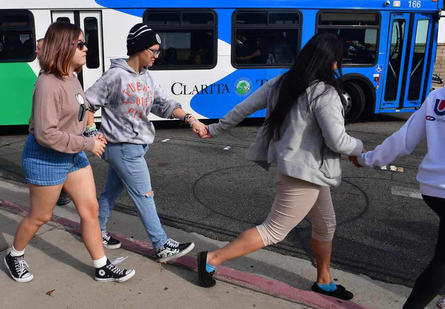 Students line up after a shooting at Saugus High School in Santa Clar