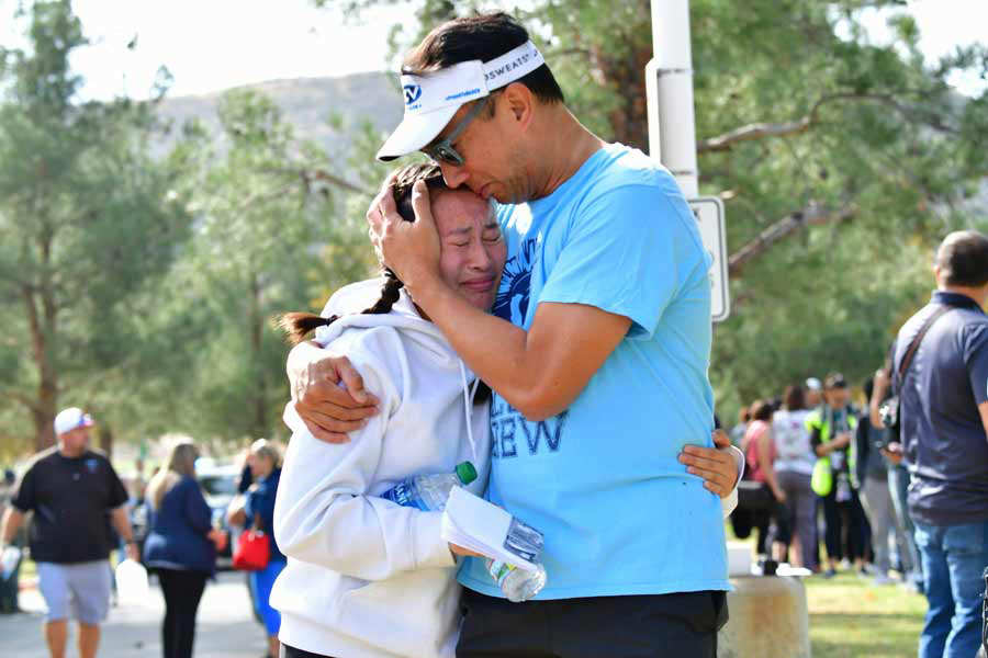 A man embraces his daughter after picking her up at Central Park