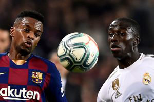 Barcelona's Portuguese defender Nelson Semedo (L) vies with Real Madr