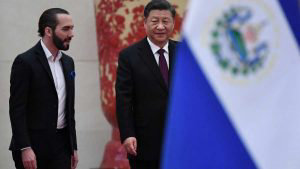 China's President Xi Jinping (R) walks with El Salvador's President N