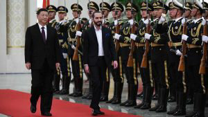 El Salvador's President Nayib Bukele (C) walks with China's President