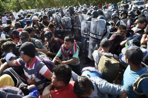 Members of the Mexican National Guard scuffle with Central American m