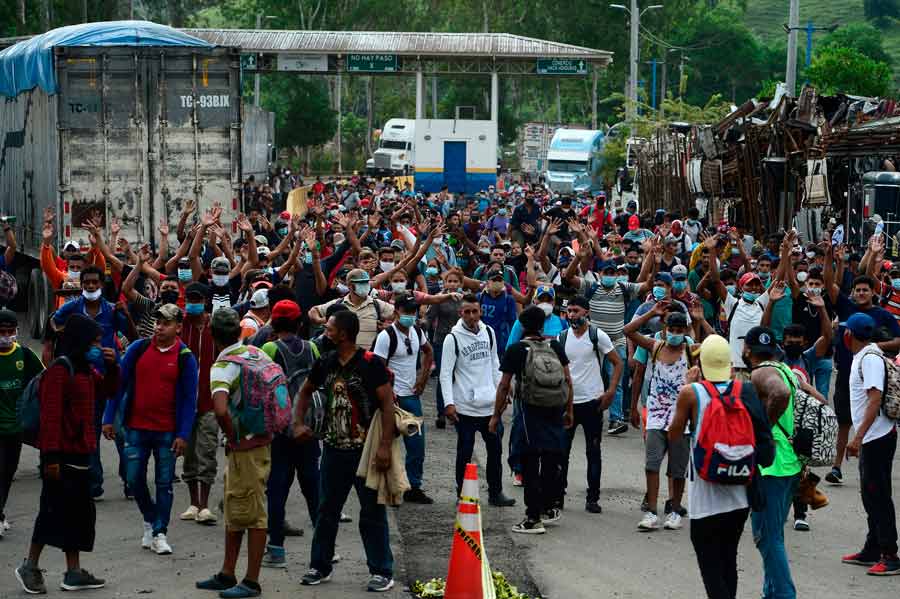 Honduran migrants are seen after breaking a police fence and entering