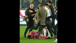 FBL-TUR-SUPERLIG-MKE ANKARAGUCU-RIZESPOR Turkish Referee Halil Umut Meler (ground) cover itself as MKE Ankaragucu's president Faruk Koca (L) attacks him at the end of the Turkish Super Lig football match between MKE Ankaragucu and Caykur Rizespor at Eryaman Stadium in Ankara, on December 11, 2023. depo photos / AFP