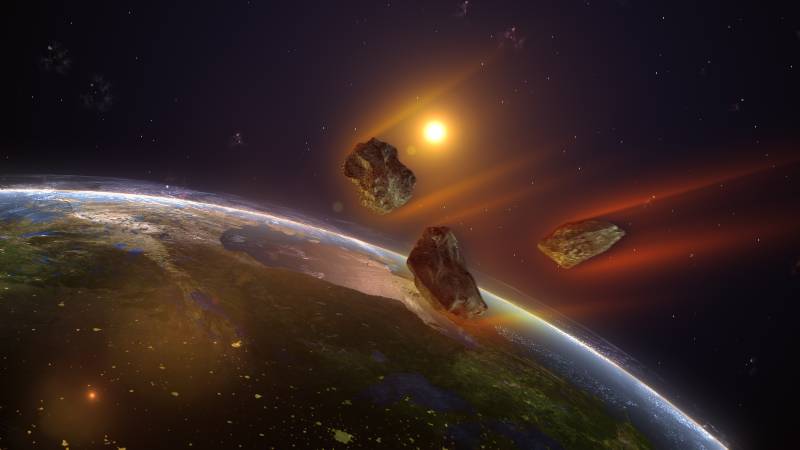 Ilustración de meteoritos cayendo en dirección al planeta Tierra