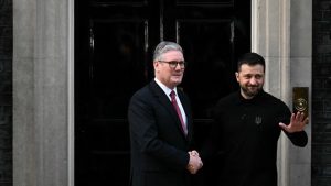 Ukraine's President Volodymyr Zelensky (R) shakes hands with Britain's Prime Minister Keir Starmer