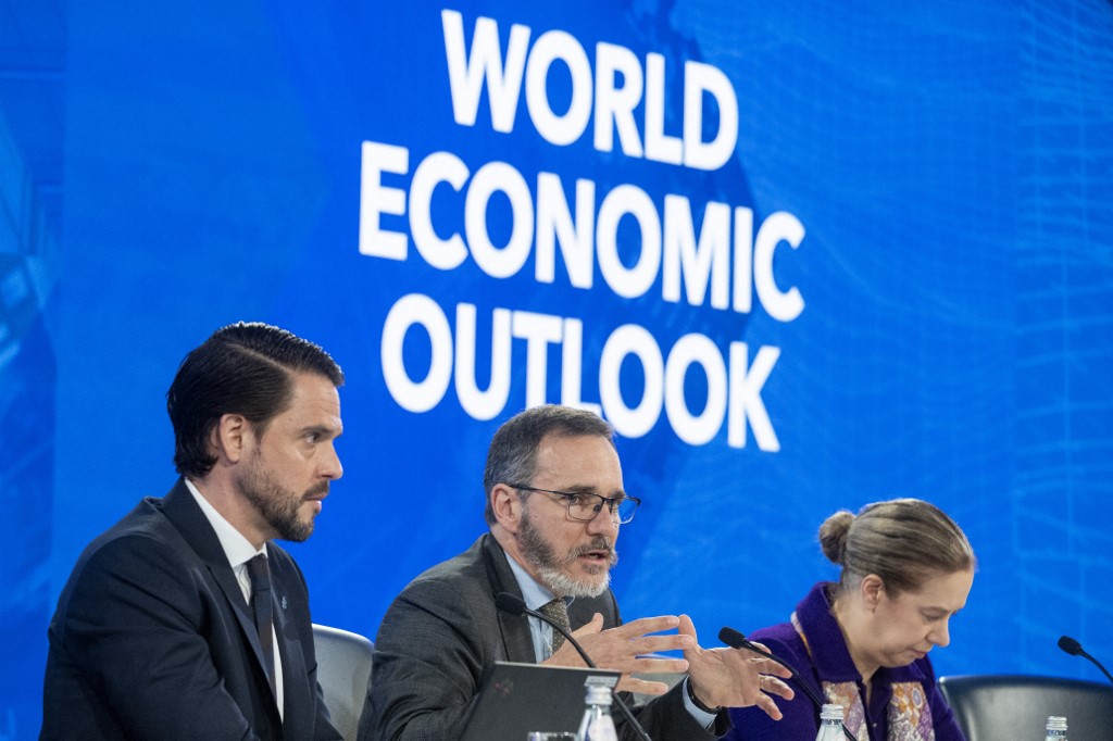 International Monetary Fund (IMF) Chief Economist Pierre-Olivier Gourinchas (C) and IMF Research Department Deputy Director Petya Koeva Brooks (R) take questions as they speak on the 